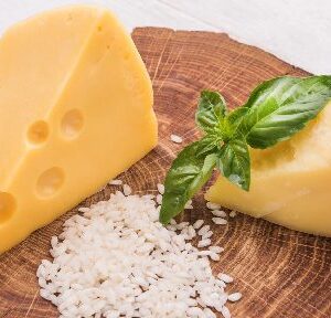 A picture of Baby swiss cheese slices on the wooden tray