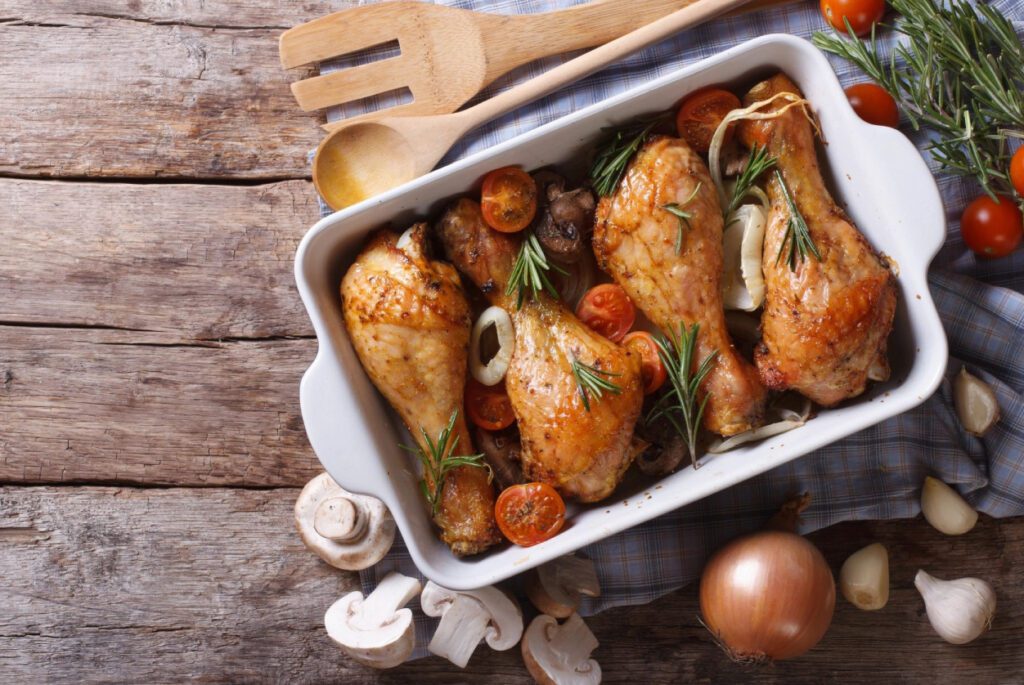 A white pan filled with chicken and vegetables.