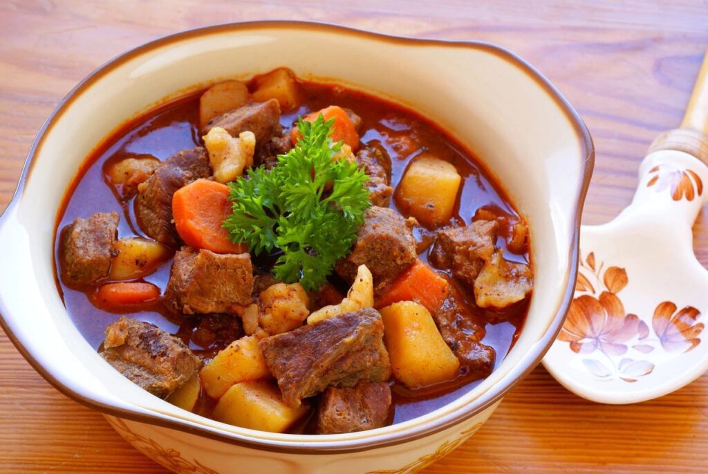 A bowl of stew with meat and vegetables.